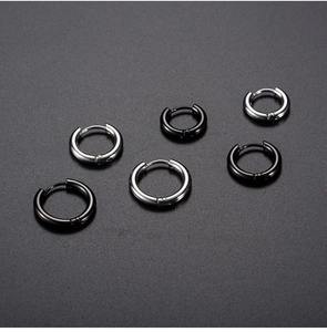 Detail view of black and silver stainless steel hoop earrings in various size diameters