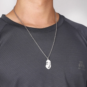 Minimalist silver-toned abstract face pendant necklace with long chain on male model