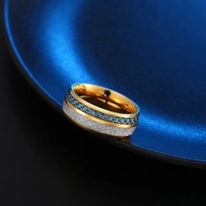 Macro detail of titanium ring featuring blue carbon fiber and silver leaf inlay