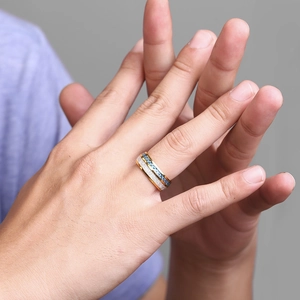 Close-up of men stainless steel ring featuring gold, silver, and blue carbon fiber inlay