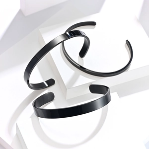 Three-piece set of polished black stainless steel open bangles with a sleek mirror finish