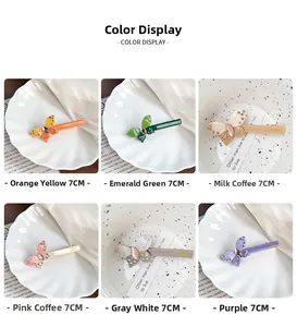 Detail of 7cm handmade butterfly hair clips showing various colors and rhinestone accents