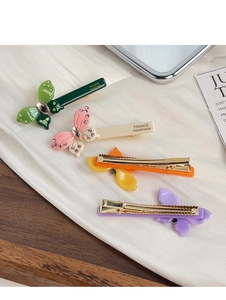 Detailed macro view of colorful butterfly hair clips with shimmering crystal accents