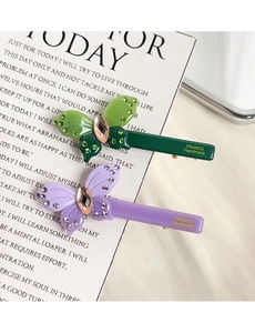 Detail view of acetate butterfly hair clips with crystals and FRANCE Handmade gold text