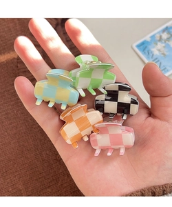 Close-up of five colorful checkered acetate mini hair clips held in a hand for size comparison