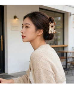 Cute Corgi-shaped hair claw clip made of acetate worn by a woman at a cafe