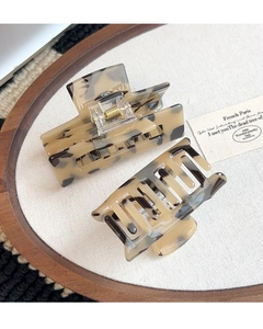 Detailed macro view of French tortoiseshell acetate hair claws with gold springs