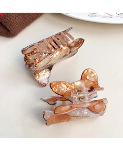 Close-up of animal-shaped hair claw clips with amber resin texture and metal springs