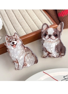 Detailed view of dog-shaped hair claws with marble texture on a wooden display