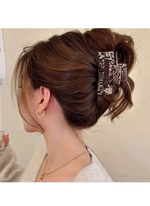 French leopard print hair claw clip shown in a stylish half-up hairstyle on model