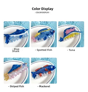 Detail showing five creative fish-shaped acetate hair claws on a light blue water background
