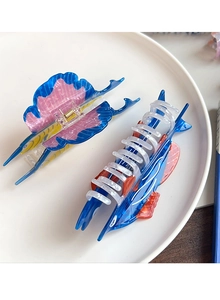 Detail of blue swordfish and colorful sea animal hair claws on a ceramic tray