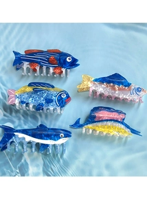 Creative set of five colorful fish-shaped hair claws displayed on a blue water ripple background