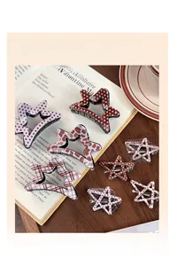 Close-up of star-shaped hair claws and clips in leopard print, polka dot, and plaid patterns