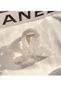 Macro detail of iridescent mermaid tail hair claw clip with golden metal spring