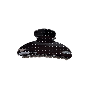 Elegant black hair claw clip with white polka dots for a vintage minimalist French hairstyle