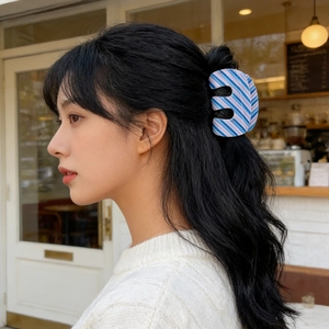 Minimalist striped hair claw clip in blue and pink for elegant women's hairstyling