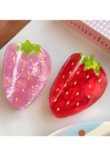 Detailed view of pearlescent pink and red strawberry hair claws with leaf accents