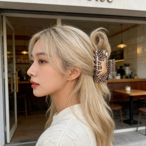 Elegant leopard print square hair claw with a gold leopard accent for stylish updo hair