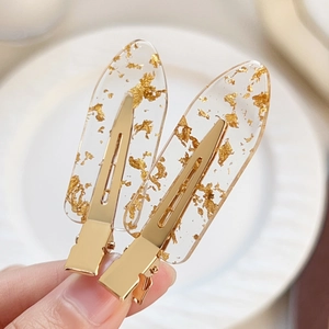 Elegant clear acrylic hair clips with gold foil flakes and metallic gold base grips