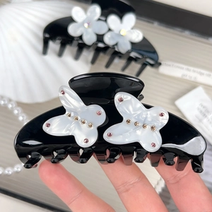 Elegant black acetate hair claw with white rhinestone butterfly accents for women