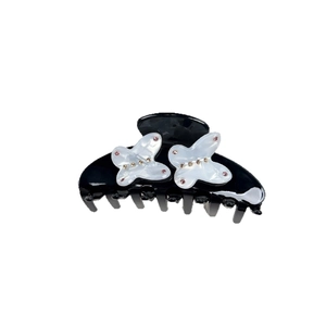 Elegant black hair claw clip featuring shimmering butterfly designs with pink rhinestones