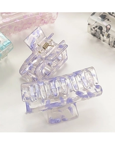 Detailed macro view showing the purple floral acetate hair claw with durable metal spring