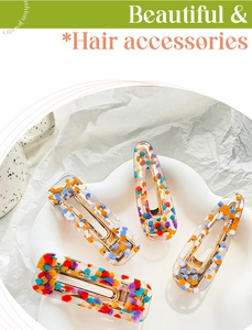 Close-up of colorful acetate hair clips with vibrant confetti patterns on a tray