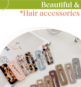 Detailed set of acetate hair clips in marble and tortoiseshell patterns on a white table