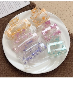 Detail view of 6-piece rectangular acrylic hair claw set with colorful marble patterns
