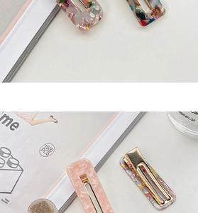 Detail view of colorful square hollow acetate hair clips with metallic gold duckbill base