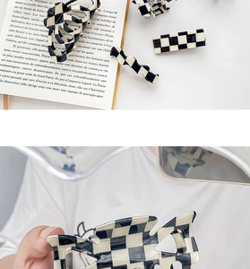 Detail of checkered hair claws and clips in vintage black and white acetate finish