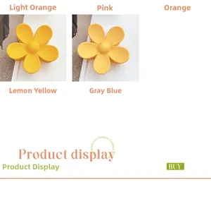 Detail view of colorful matte flower hair claws in orange and yellow candy colors