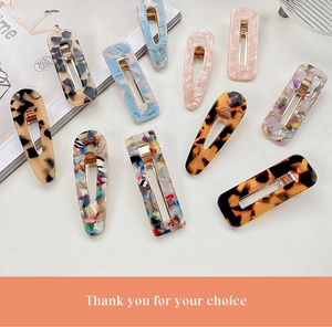 Detail of assorted tortoiseshell acetate hair clips with golden metal duckbill bases