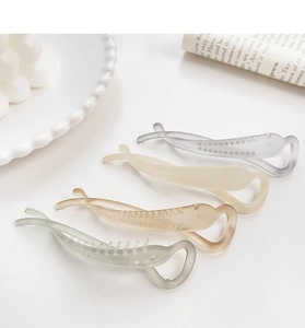Detail of matte translucent banana clips in four colors for elegant hair styling