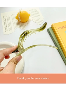 Close-up of translucent matcha green banana hair clip with internal teeth detail