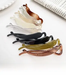 Detail showing various colors of elegant matte banana clips with non-slip comb teeth