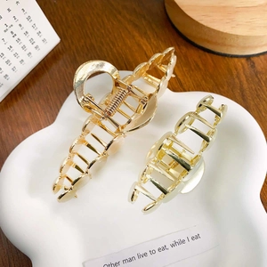 Elegant gold metal shark hair claw clips set with white opal accents for women