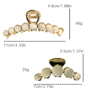 Golden alloy claw clips with opal stones in large and small sizes on white background