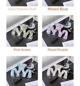 Close-up of wavy acetate hair claws in rice tortoise, blue, pink and purple colors