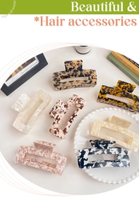 Detailed view of 13cm oversized acetate hair claws in various marble and tortoiseshell patterns