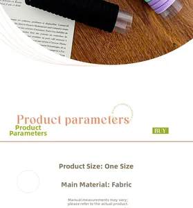 Close-up of thick elastic hair ties in black, purple, and green on a wooden surface
