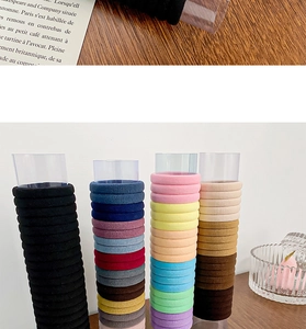 Detail of high-elasticity seamless hair ties in assorted colors on a wooden surface