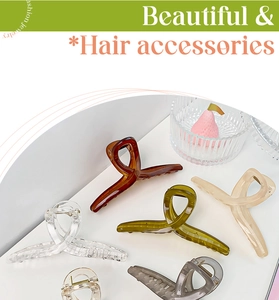 Overhead view of various 13cm matte hair claw clips in Morandi colors on white surface