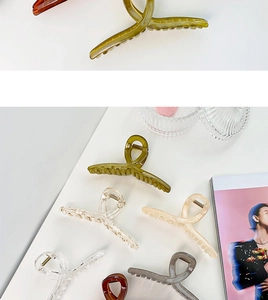 Macro shot of 13cm oversized hair claw clips in assorted Morandi colors on a stylish background