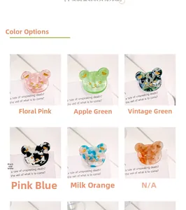 Vue détaillée de pinces à cheveux ours en acétate avec six couleurs marbrées variées