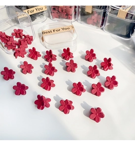 Mini matte burgundy flower hair claws set in a transparent storage box for styling