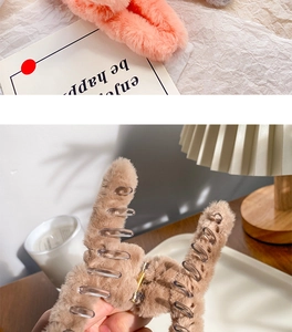 Detail of coral pink and beige plush hair claws showing soft faux fur texture and spring