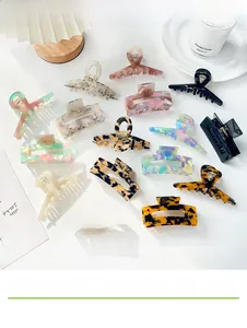 Variety of marble and tortoiseshell acetate hair claws in various shapes on a white table