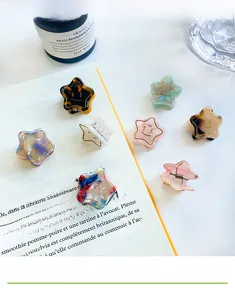 Detail of starfish acetate hair clips with marble texture and smiley face designs